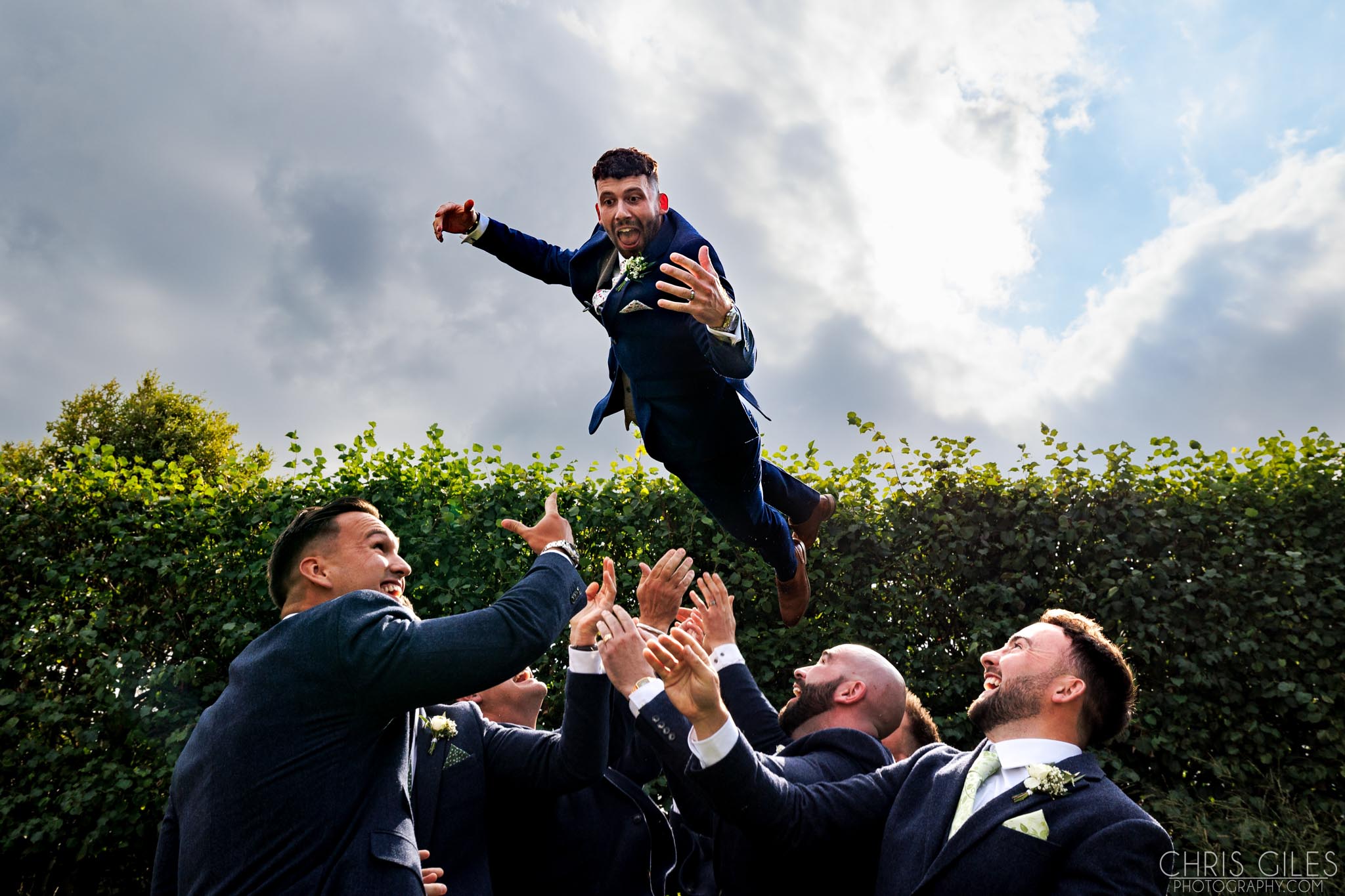 Groom being thrown in the air at Southend Barns
